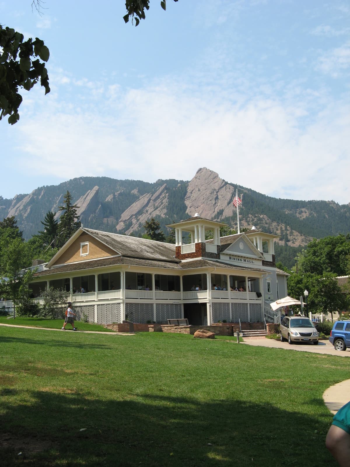 The wraparound porch of the Chautauqua Dining Hall with the Boulder foothills behind it