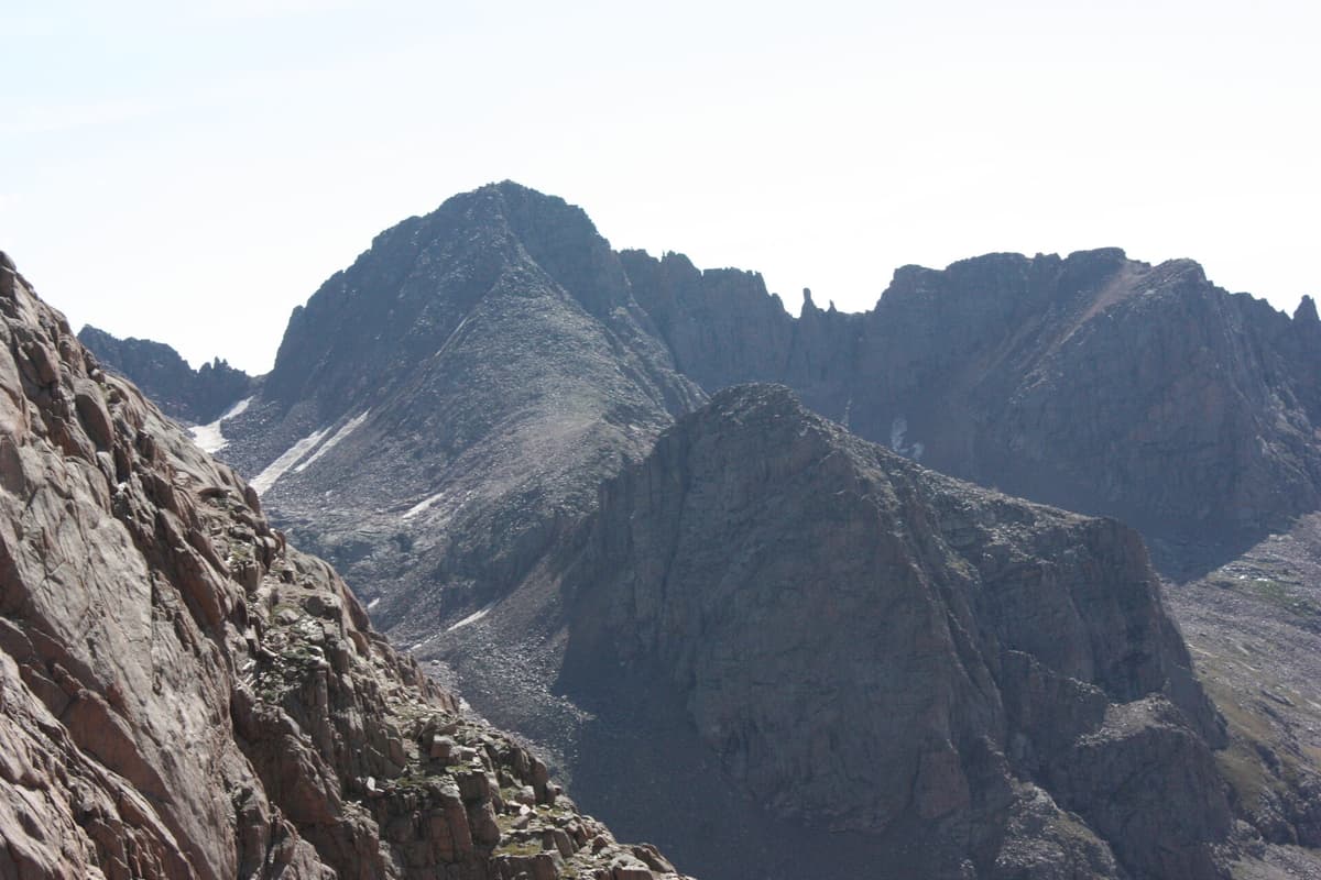 Windom Peak and neighboring summits rising above the trees of Chicago Basin