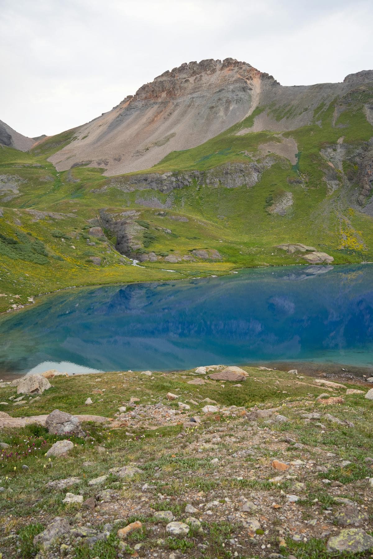 bright blue alpine lake surrounded by Colorado mountain scenery 