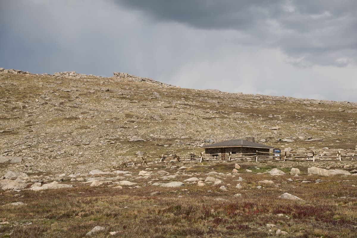 The historic stone shelter house at Summit Lake Park, built in 1924, standing on the tundra