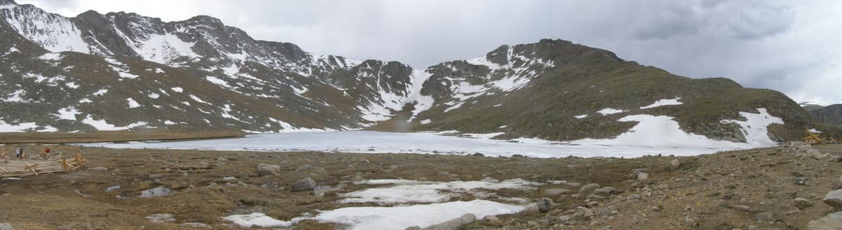 A wide view across Summit Lake with the Mount Blue Sky ridgeline rising behind the water