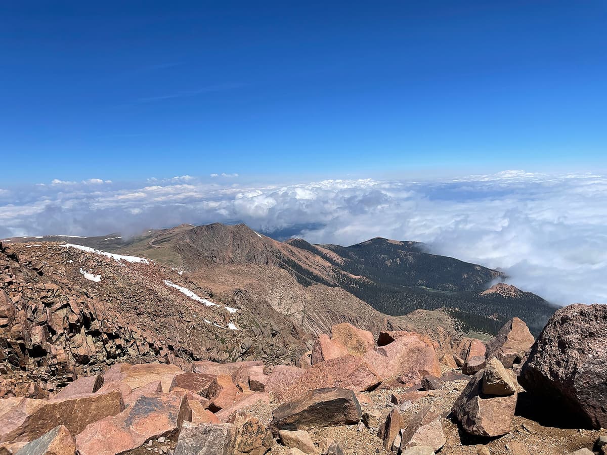 Above the clouds near the Pikes Peak summit, the payoff for the long route up from the Crags