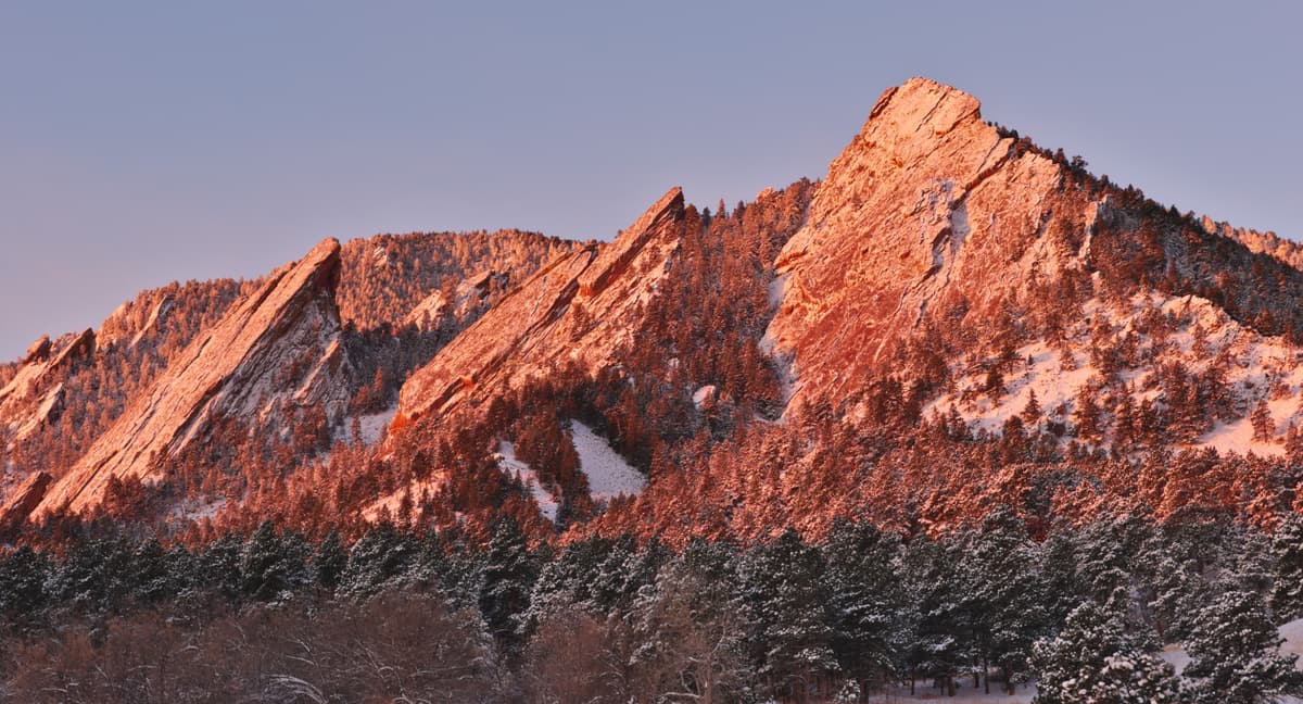The Flatirons at sunrise rising above Boulder, Colorado