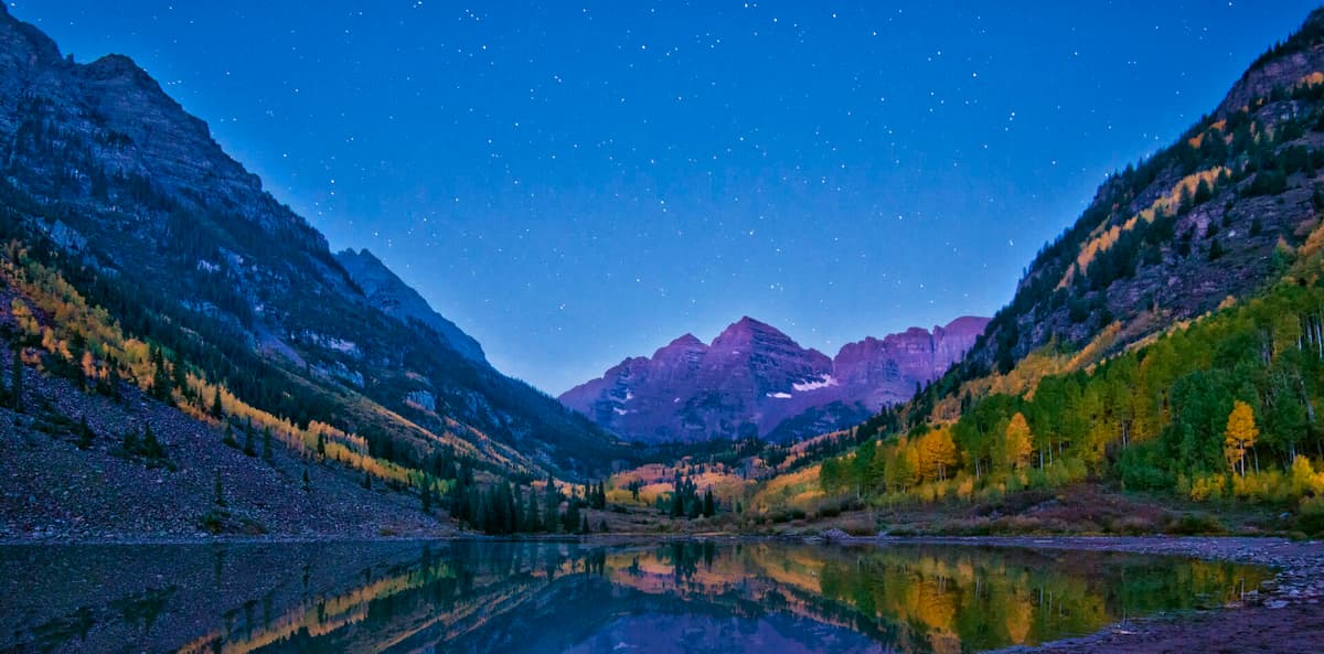 Alpenglow and fall color on the Maroon Bells above Maroon Lake