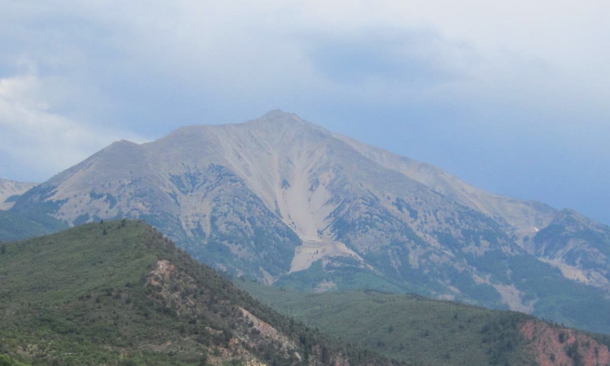 Mount Sopris in late summer with bare talus slopes and a large scree fan below the summit ridge