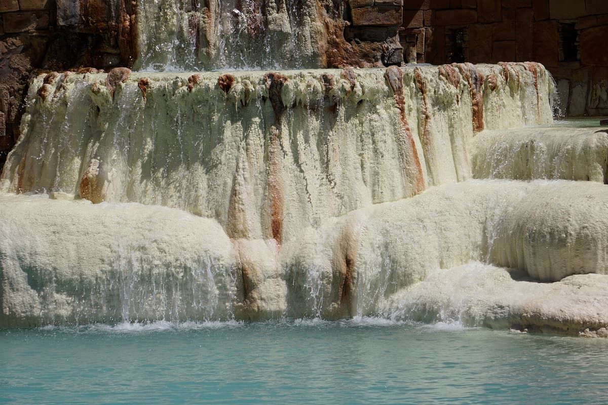 Colorful mineral water pooling at the Mother Spring in Pagosa Springs, recognized as the deepest measured geothermal hot spring in the world