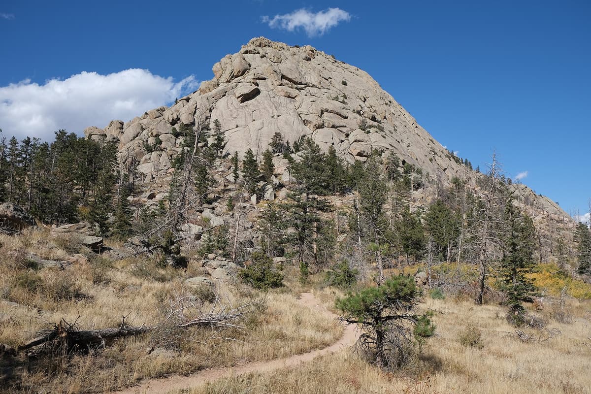 Mountain trail climbing toward a rocky Colorado summit