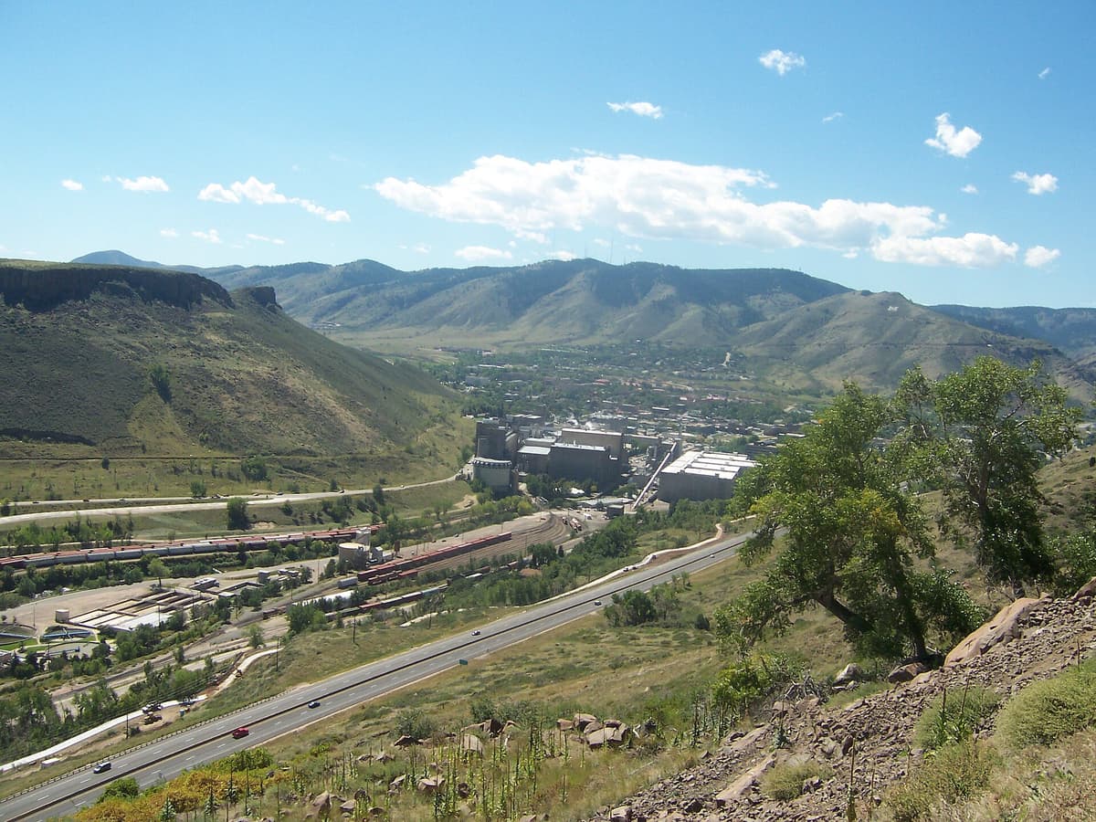 Looking down over Golden, the Coors brewery, and Clear Creek Canyon from the rim of a Golden table mountain