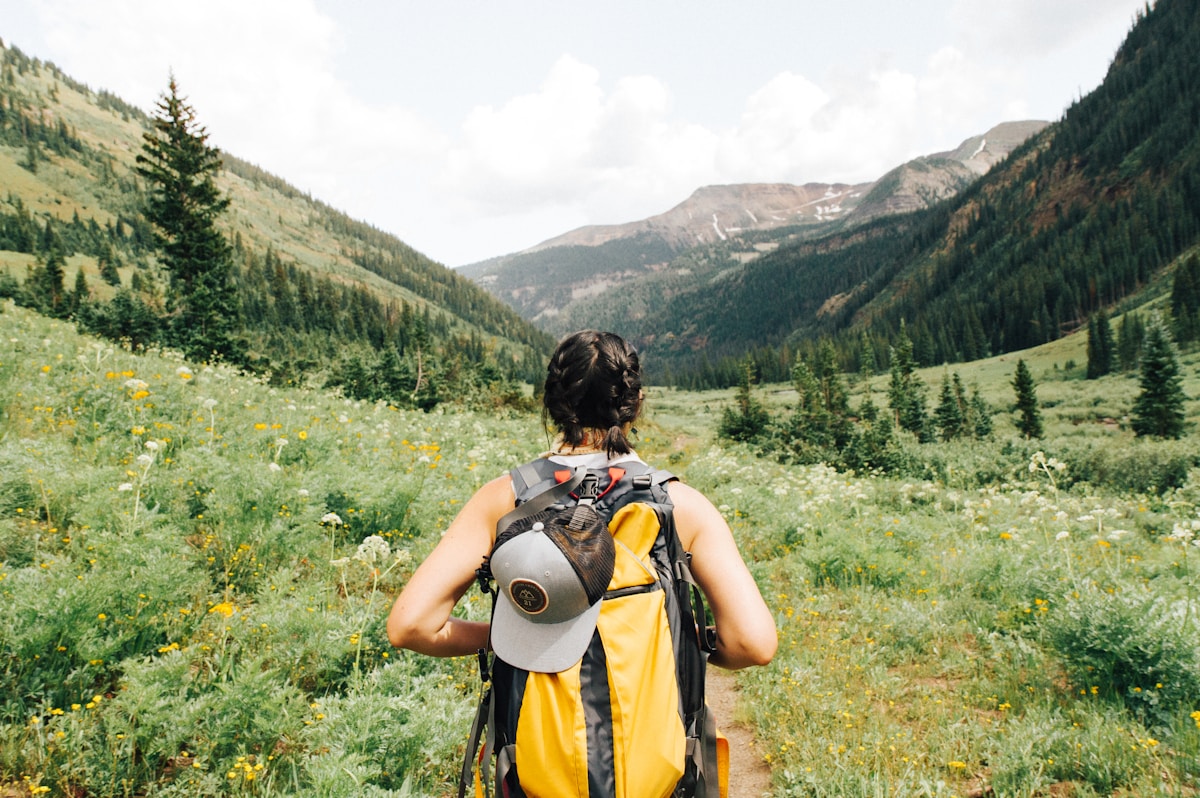Hiker with daypack on mountain trail